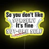 Neon sign with yellow letters spelling out "Sut-ure Self-Surgery Pun