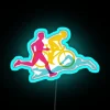 Neon sign with RGB colors, featuring the logos of swim, bike, and run in a triathlon theme.