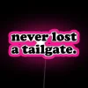 Neon tailgate sign with pink glow effect in RGB color scheme.