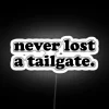 Neon tailgate sign in RGB colors, glowing against a white background.