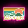 Neon sign with pink lettering reading 'Take a Hike'