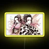 Demon Slayer duo Tanjiro and Nezuko standing back-to-back under a neon sign, in a bright yellow background.