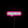 TechnoBlade neon sign with RGB colors, featuring a quote that says "Welcome Home Theseus" in bold pink letters.