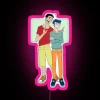 Teen Shin Chan and Kazama standing in front of an RGB neon sign, showcasing vibrant pink colors.