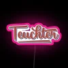 Neon sign reading "Teuchter Doric Dialect" in pink, Scottish Gaelic-inspired letters against a dark background.