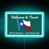 Neon sign reading 'The Texas Way' with blue color scheme, highlighting Texas state's drive friendly reputation.