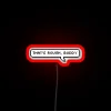 A vibrant RGB neon sign with bold red letters reading 'That's rough buddy'