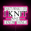 Neon sign with pink letters reading 'That's what I do, I knit and I know things'