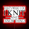 Neon sign with colorful letters reading "That's What I Do, I Knit and I Know Things" in a playful, cursive font.