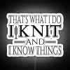 Neon sign with colorful typography displaying knitting-related phrase
