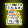 Neon sign with multicolored, cursive letters spelling out "That's what I do" surrounded by book and crochet elements in pa...