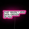 Neon sign with RGB colors and pink hue, featuring a humorous phrase about data-driven decision making.