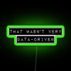 Green neon sign with pixelated font, implying lack of data-driven approach.
