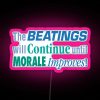 Neon sign with pink letters reading 'The beatings will continue until morale improves'