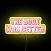 A neon sign reading 'The Book Was Better'