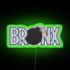 Neon sign reflecting colorful RGB hues in The Bronx at night.