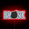 Neon sign with red lettering in The Bronx neighborhood at night