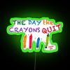 A colorful city street sign at sunset with vibrant green neon lights reading "The Day The Crayons Quit