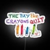 Vibrant neon sign reading 'The Day The Crayons Quit' in bold, colorful letters.