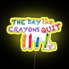 Neon sign reading "The Day the Crayons Quit" in bold yellow letters.