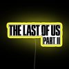 The Last of Us Part 2 logo featuring a neon sign design with vibrant yellow accents.