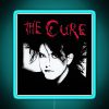 A bold, neon sign reading 'The Man Cure' in red text on a blue background.