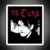 Neon sign with red text reading "The Man Cure