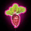 Dwight Schrute standing in front of a neon sign with a beet logo, showcasing his pride for beets.