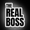 Neon sign reading 'The Real Boss' in bold, colorful lettering.