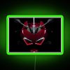 Neon sign with red and green colors, illuminated at night.
