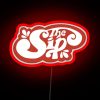Retro neon sign with red RGB lighting in a bar or nightclub setting.