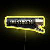 Neon sign with the colorful logo of The Streets in bright yellow hues.