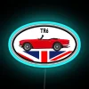 Neon blue sign featuring a retrofuturistic TR6 convertible.