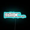 The Truman Show film set, a vibrant blue neon sign reading "The Truman Show" in bold, futuristic letters against a dark ci...
