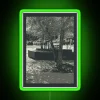 Neon sign illuminating a walkway in vibrant green hues.