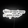 A colorful neon sign reading a humorous quote about video games.