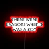 Neon sign reading 'There Were Dragons When I Was A Boy' in vibrant RGB colors.