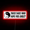 Neon sign reading 'Thick Dads 4 Christ' in bold, colorful letters.