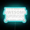 A supervisor standing confidently with a colorful neon background, wearing a bright smile and a badge that reads "Awesome...