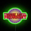 Neon sign reading 'Threat Level Midnight 1' in a futuristic, glowing green font.