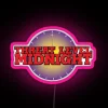 Neon sign with glowing pink letters reading 'Threat Level Midnight'