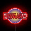 Neon Threat Level Midnight sign with glowing red letters against a dark background.