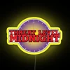 Neon sign reading Threat Level Midnight in bold, yellow letters.