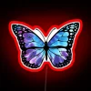Neon tie-dye butterfly on a colorful sign in bold RGB red hues.