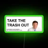 Neon sign reading 'Take out the trash' in green letters on a dark background.