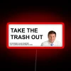 Neon sign reading 'Take Out the Trash' in bold, red letters.