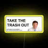 Neon sign with colorful, glowing letters reading 'Take out the trash'
