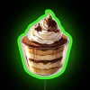 Tiramisu cake with neon green accents on top.