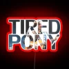 A tired pony standing in front of a neon sign that reads "41585" in red, with a hint of urban nightlife ambiance.