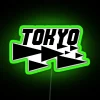 Neon Tokyo street sign with green glow at night.